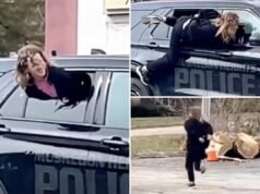 Un video selvaggio cattura una donna ammanettata che esce dall’auto della polizia del Michigan e corre via