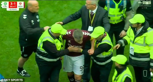 108656549-15824059-Hearts_skipper_Lawrence_Shankland_had_to_be_helped_away_by_stewa-a-40_1778956563805.jpg