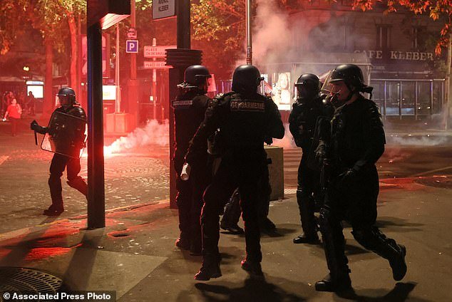 108990813-15862007-Police_try_to_disperses_PSG_supporters_who_left_off_fireworks_as-a-82_1780225396380.jpg