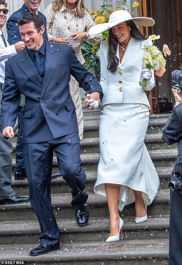 108993131-15861977-The_newlyweds_beamed_as_they_headed_outside_to_be_showered_with_-m-2_1780241263102.jpg