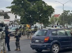 Soldati messicani guardano gli uomini armati del cartello attaccare il corteo funebre