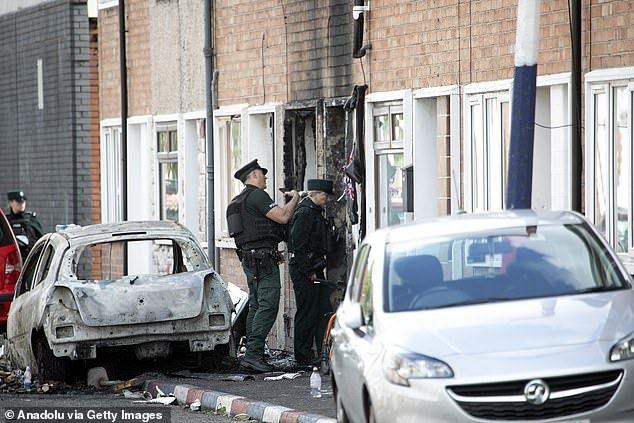 109259423-15889441-Police_assess_the_damage_to_a_burnt_out_house_in_east_Belfast_af-m-2_1781107360943.jpg