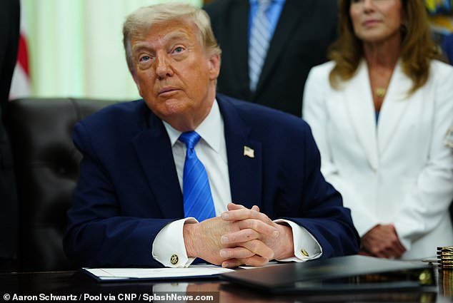 109287771-15893001-Donald_Trump_displays_the_signed_Secure_America_Act_in_the_Oval_-a-54_1781204937983.jpg