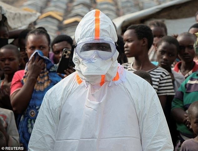 109562559-15925635-A_health_worker_in_personal_protective_equipment_PPE_stands_near-m-41_1782296619746.jpg