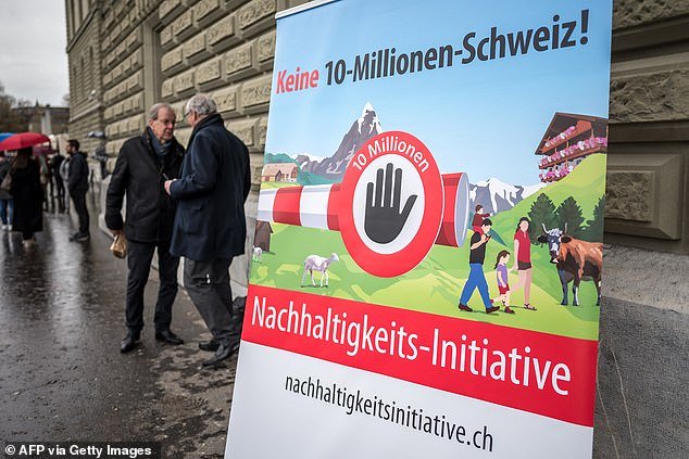 91805919-15898719-Representatives_of_the_Swiss_People_s_Party_SVP_UDC_stand_next_t-a-1_1781434930302.jpg