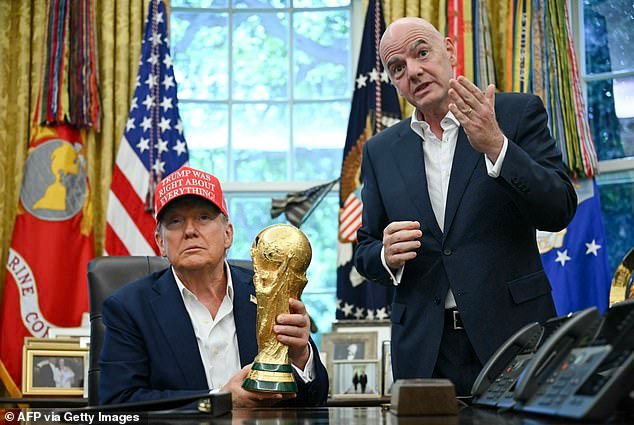110017217-15977623-Donald_Trump_holds_the_World_Cup_trophy_next_to_FIFA_president_G-a-1_1784065187203.jpg