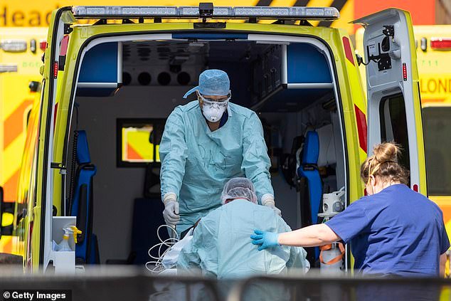 96012835-15975491-File_photo_of_NHS_workers_in_PPE_taking_a_patient_to_hospital_in-a-2_1784024745474.jpg