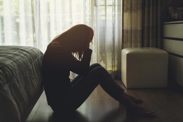 depressed-woman-sitting-head-hands-133610490_22571d.jpg