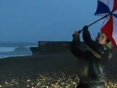 Il giornalista televisivo con l’ombrello in mano viene quasi spazzato via dalla tempesta Austen mentre i presentatori vengono colpiti da venti a 80 miglia all’ora